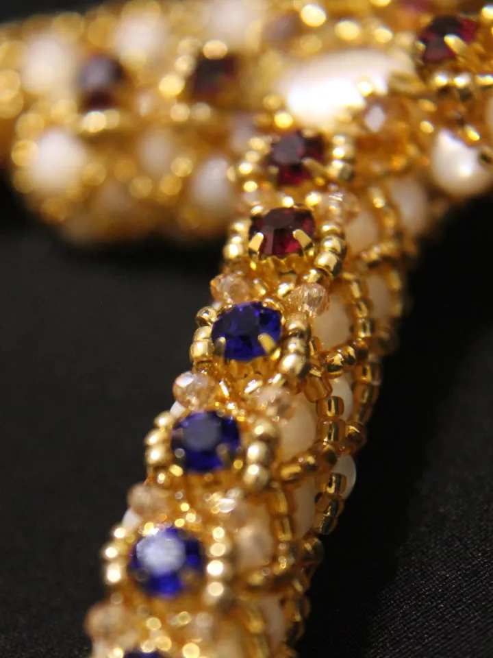 Pendant in the form of a cross woven pearls, mother-of-pearl and beads