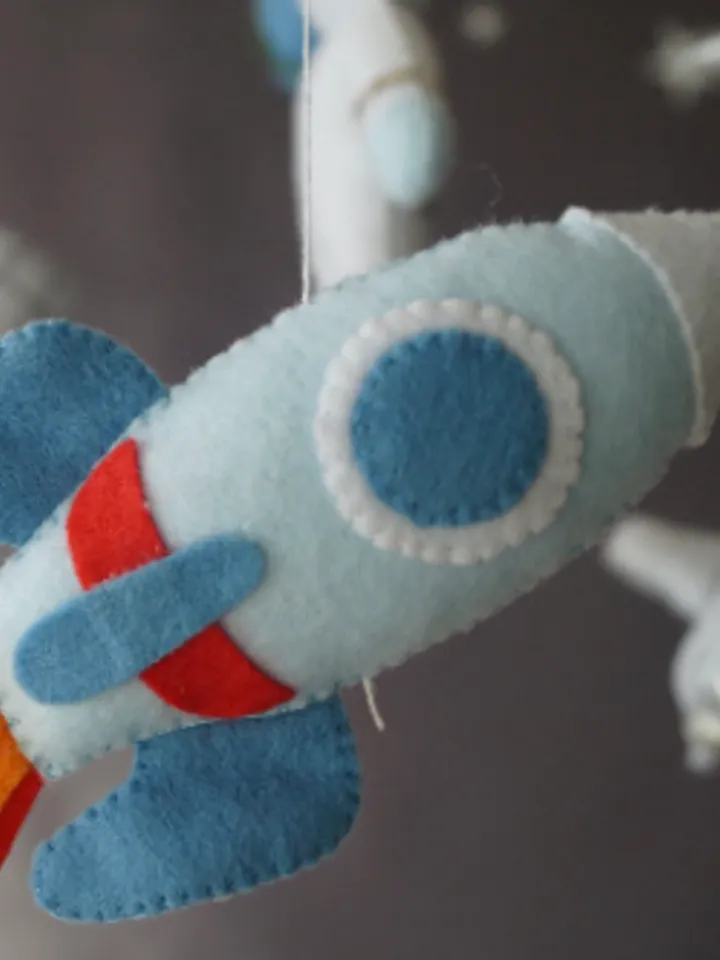 A space mobile for astronaut's nursery, a Shuttle and a rocket made of felt for the decor boy's room