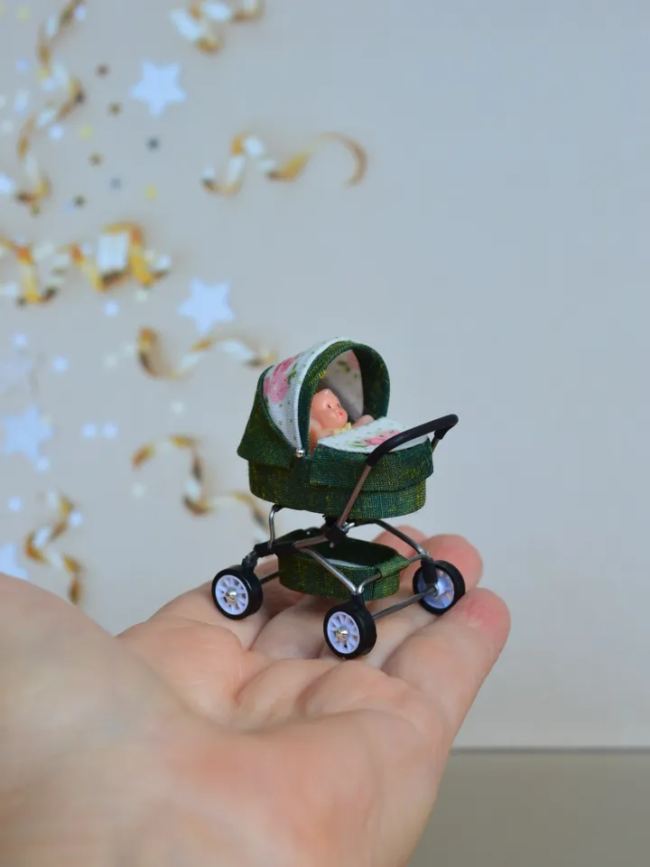 Miniature toy doll stroller in 1/24 scale. Complete with baby doll.