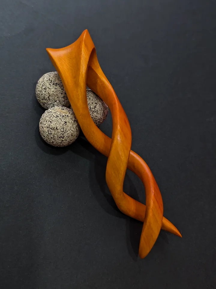 Spiral clip made of stabilized hornbeam orange. Twisted wooden hair fork.