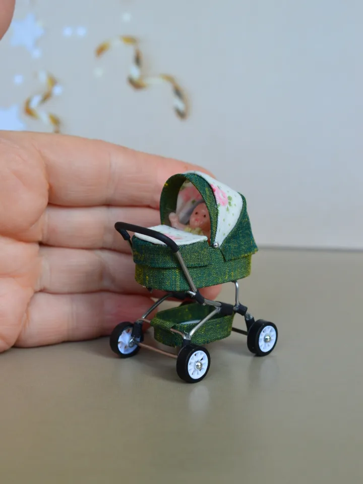 Miniature toy doll stroller in 1/24 scale. Complete with baby doll.