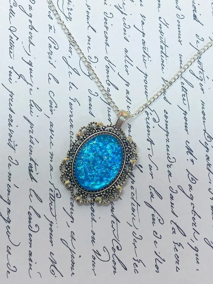 Bright, turquoise pendant on a handmade cord. Handmade jewelry with turquoise rhinestones.