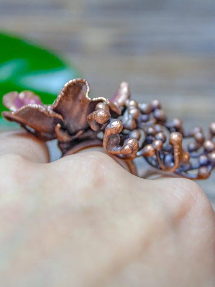 Unique handmade copper ring made from a real flower bud using the electroforming method, decorated with a Swarovski crystal