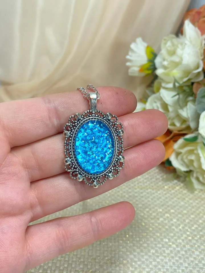 Bright, turquoise pendant on a handmade cord. Handmade jewelry with turquoise rhinestones.