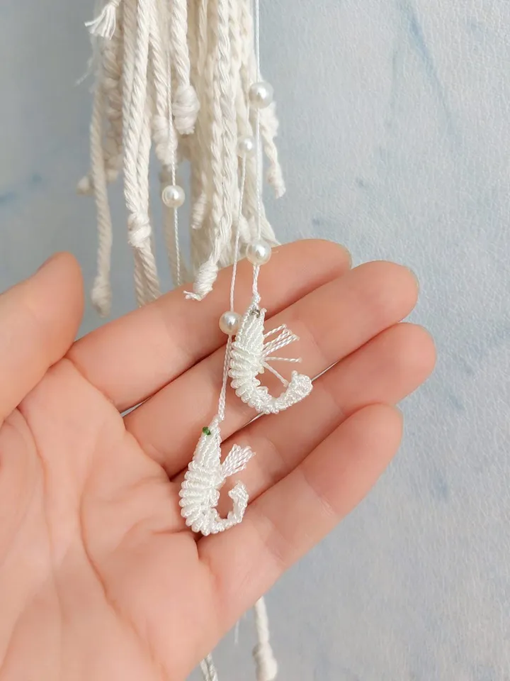 Pendant decoration in the shape of a jellyfish made of macramé. Modern macramé. Home decor in coastal style. crochet jellyfish