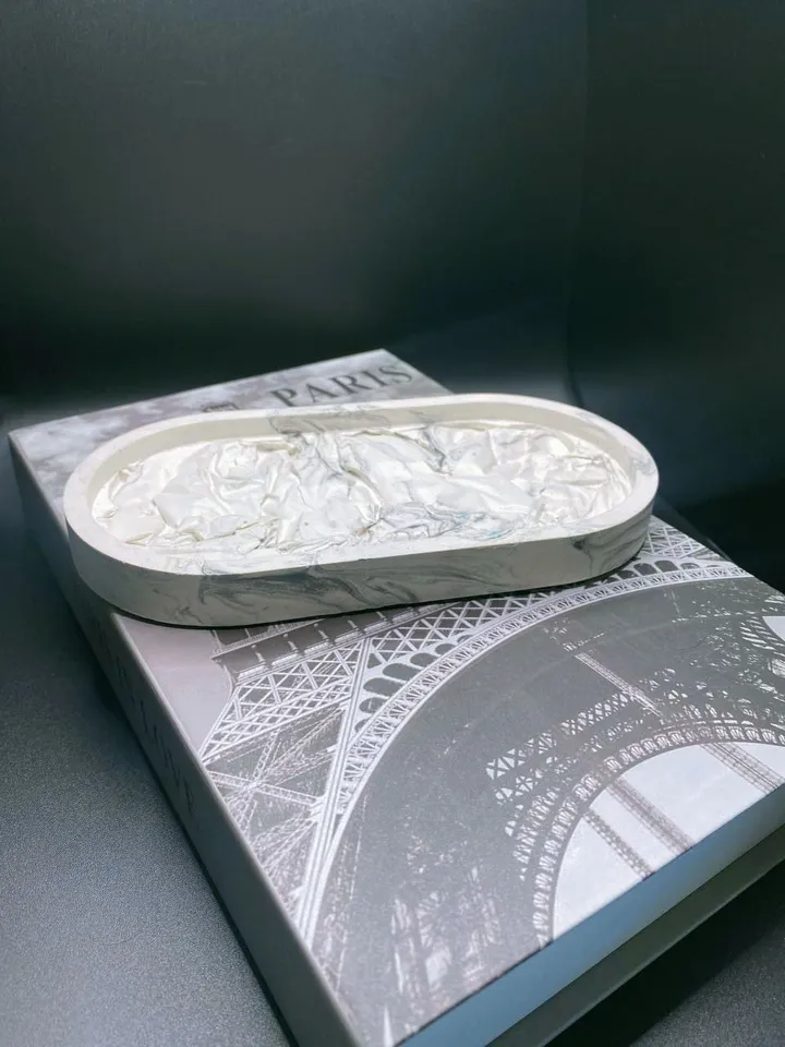 Decorative oval tray with a design solution made of plaster
