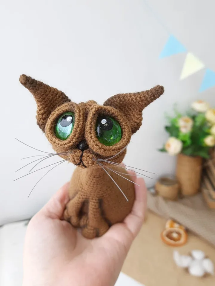 Crochet sculpture of a graceful brown cat with green eyes. Big-eyed cat as a gift for cat lovers.
