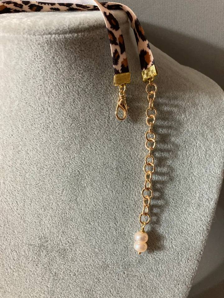 A choker around the neck on a ribbon