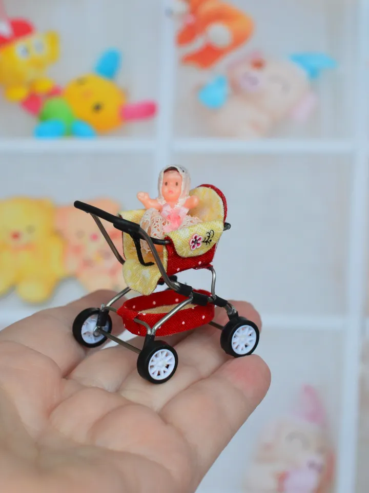 Miniature toy doll stroller in 1/24 scale. Complete with baby doll. Red handmade stroller.