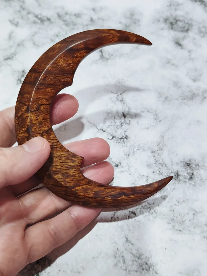Hair bun pin in the shape of a moon.