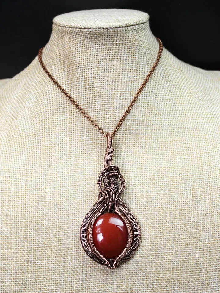 Handmade Pendant made of copper wire and natural carnelian stone