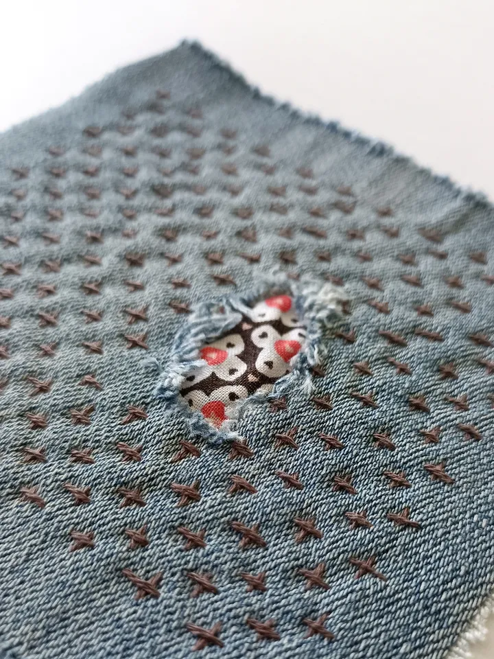 Upcycled denim boro patch. Sashiko stitching.