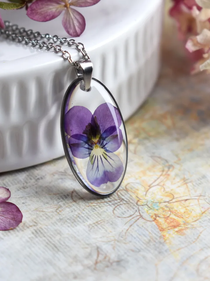 Pendant with a real pansy flower in the resin. Tiny viola flower necklace.