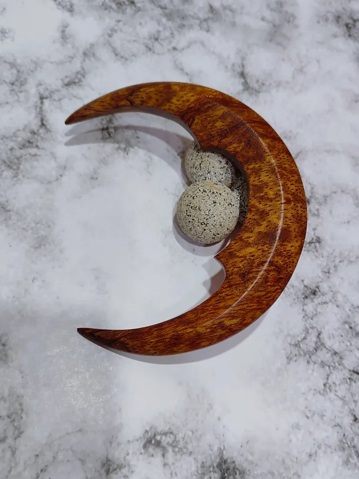 Hair bun pin in the shape of a moon.