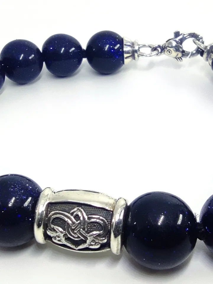 Bracelet made of natural beads, with a charm - a knot of happiness