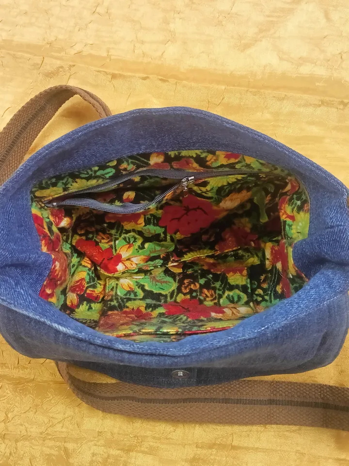 A small crossbody bag, a women's messenger bag with a tapestry flap, a denim shoulder bag with pockets inside and an adjustable strap