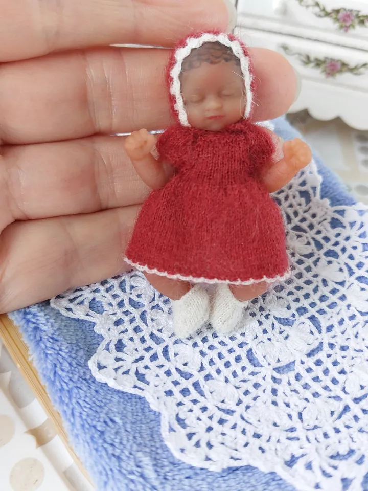 Miniature knitted red dress with white pants, socks and a hat for the silicone doll "My Mini Baby" by ZURU