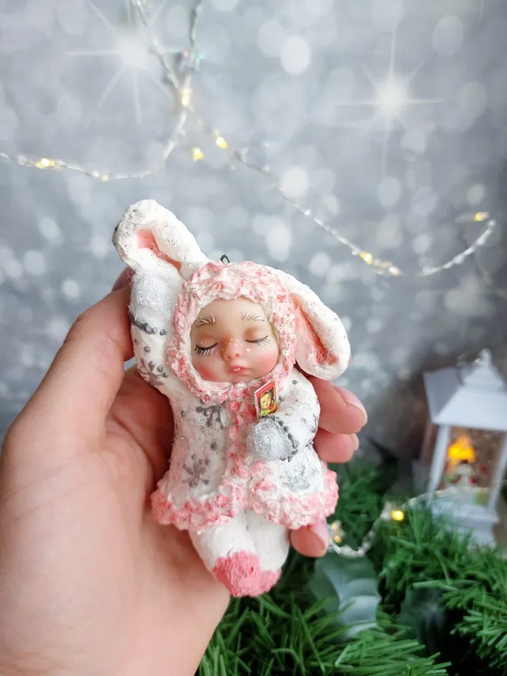 Cute Christmas tree toy made of cotton sleeping bunny. Handmade hanging toy. A gift for Christmas.