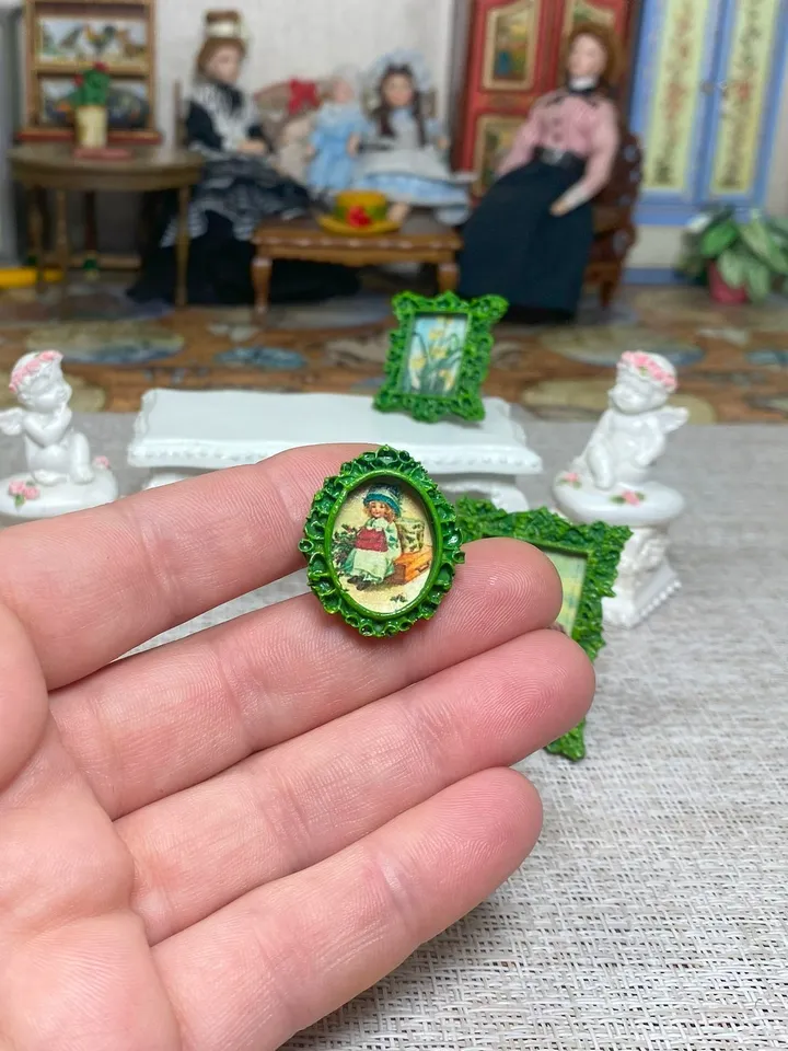 A set of frames with images of flowers. Dollhouse miniature. 1:12.
