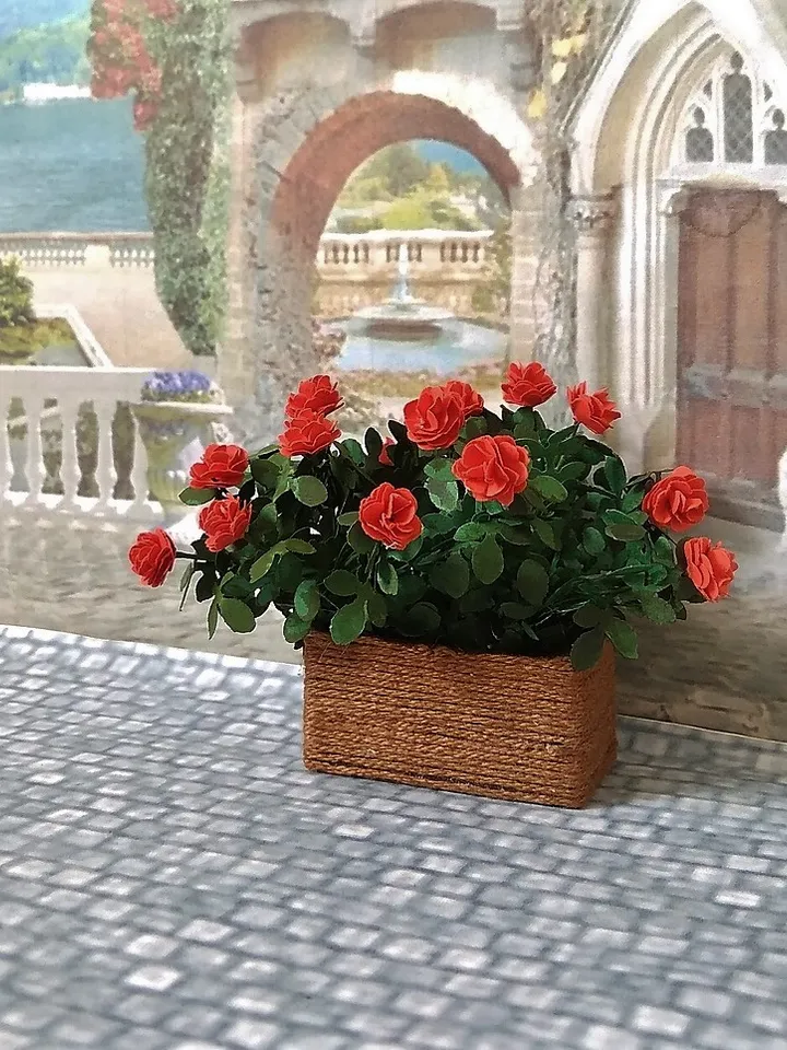 Miniature roses in a flowerpot. Dollhouse miniature.