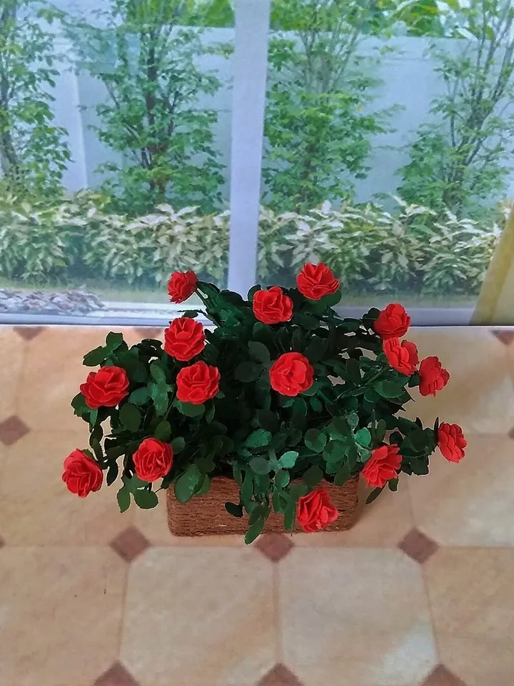 Miniature roses in a flowerpot. Dollhouse miniature.