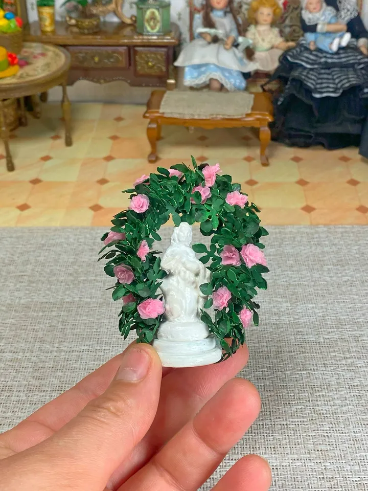 A figurine with delicate roses for a dollhouse and a park area. Dollhouse miniature. 1:12.
