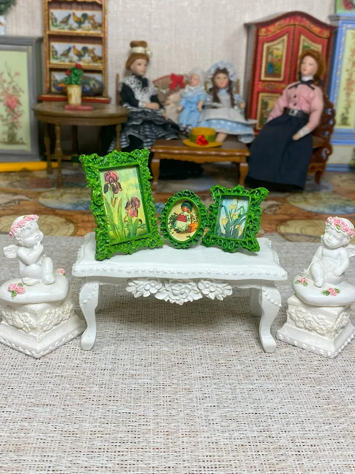 A set of frames with images of flowers. Dollhouse miniature. 1:12.
