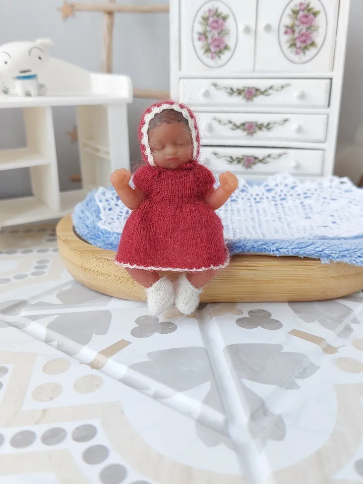 Miniature knitted red dress with white pants, socks and a hat for the silicone doll "My Mini Baby" by ZURU