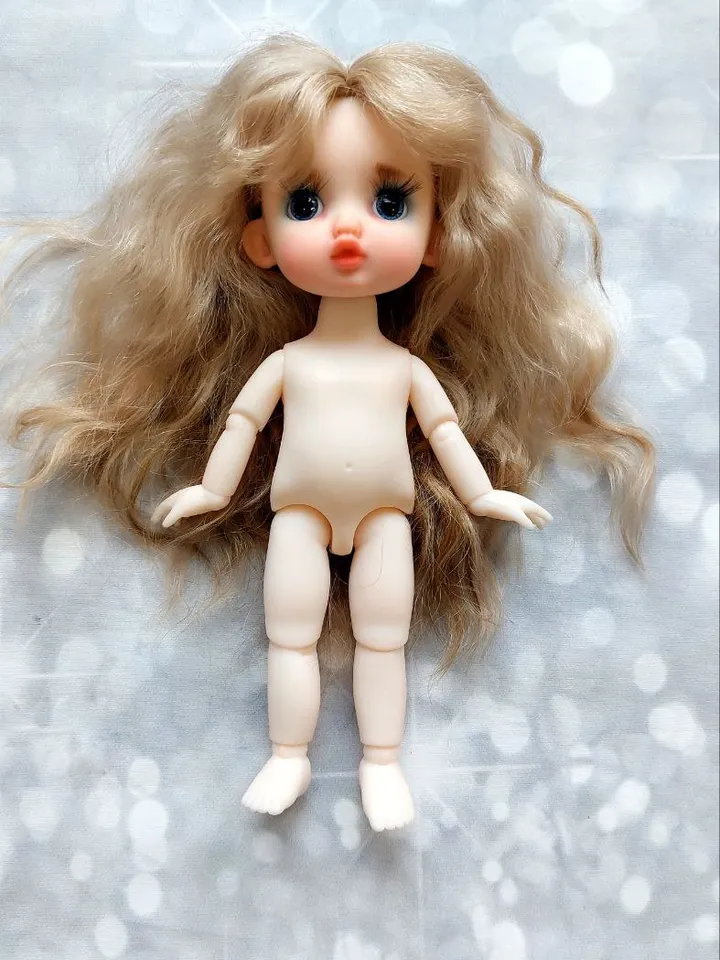 Blonde doll with blue eyes. Small doll on an articulated body.