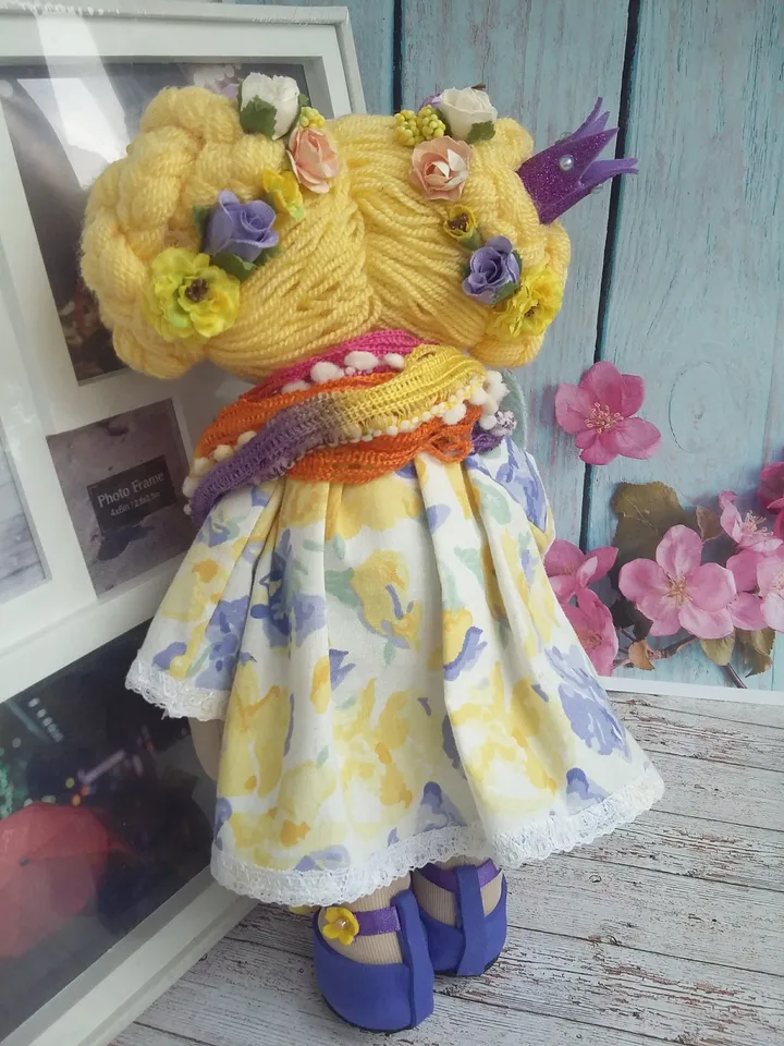 Doll Princess in the crown with an elephant in her hands, with yellow hair, beautiful, interior, birthday present, holiday