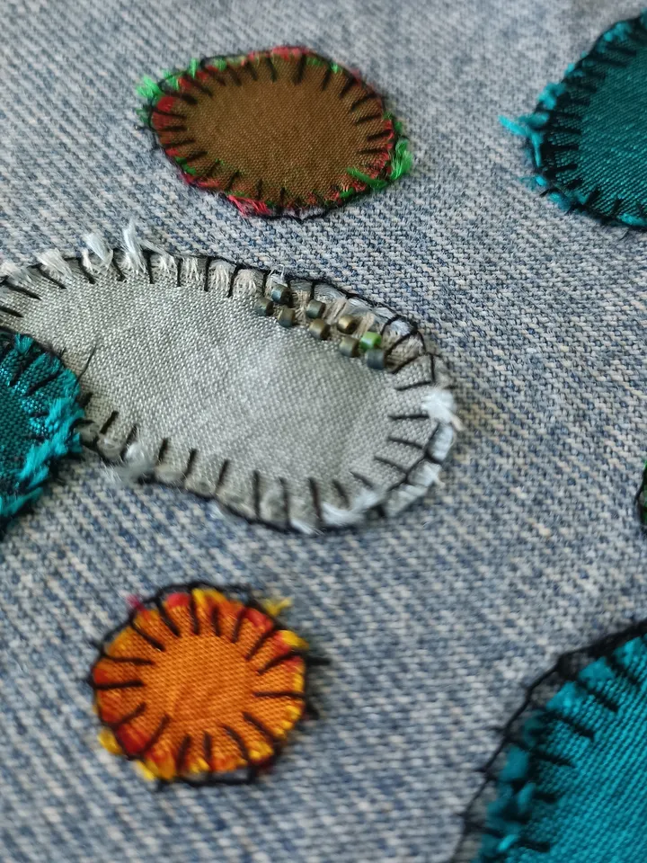 Upcycled denim/silk boro patch – visible mending.