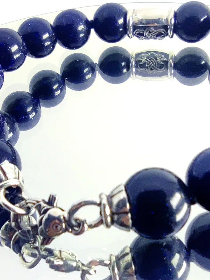 Bracelet made of natural beads, with a charm - a knot of happiness