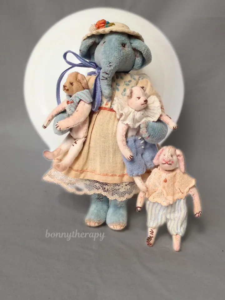 Textile elephant toy with a little friends
