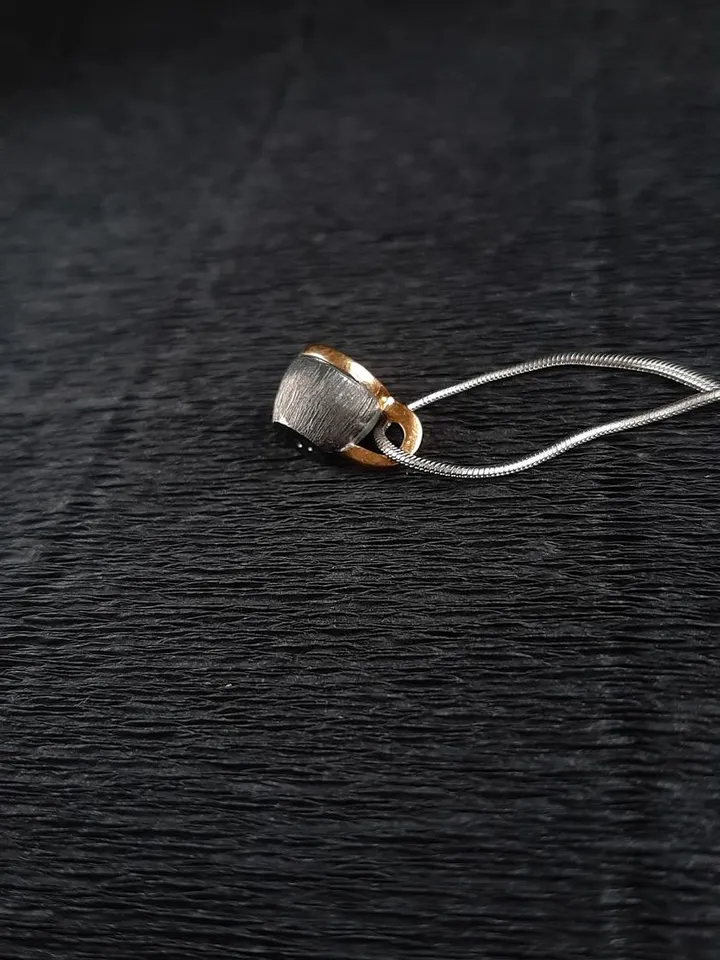 Pendant cup of coffee made of silver with gold plating.