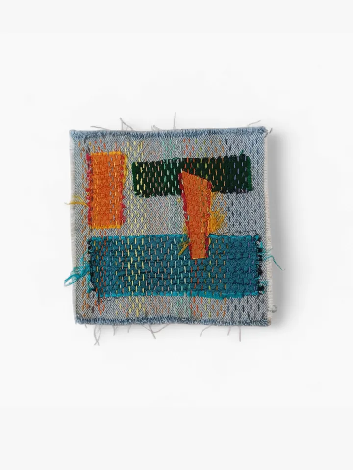Upcycled denim boro patch – visible mending.