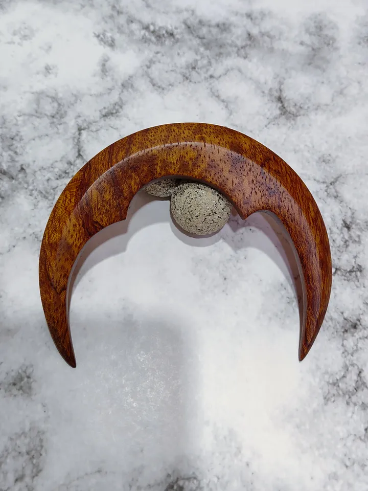 Hair bun pin in the shape of a moon.