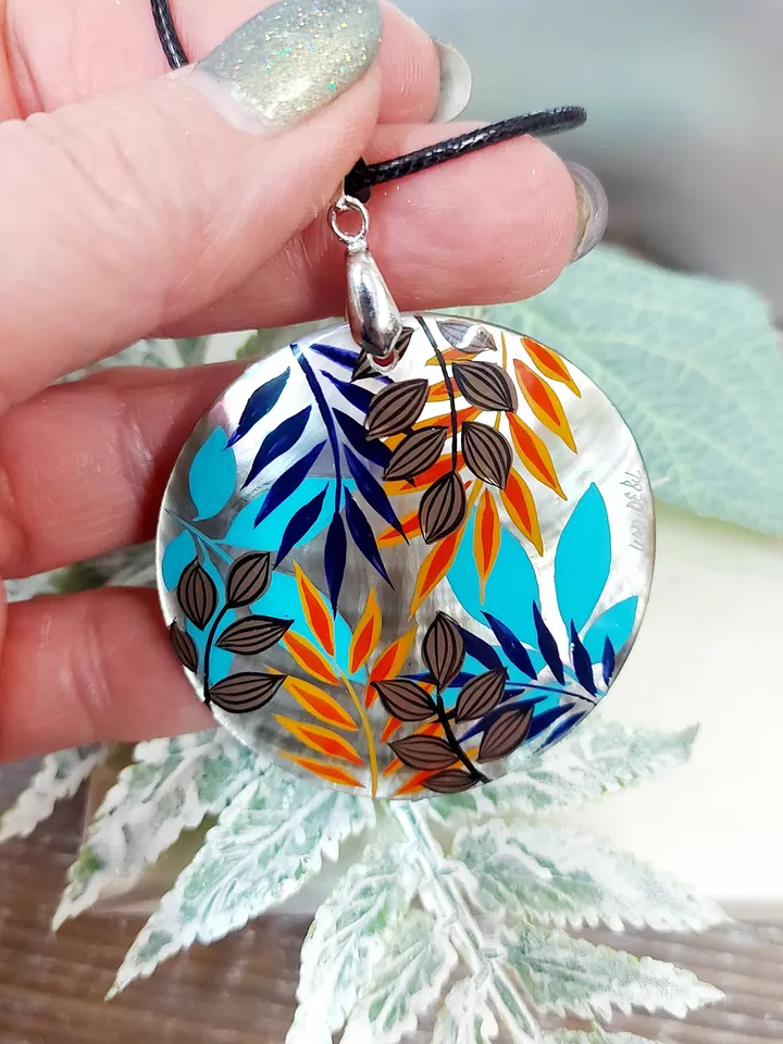 Artistic Expression in Nacre: Abstract Botanical Hand-Painted Mother-of-Pearl Pendant - Captivating Blue and Orange Leaf Motif