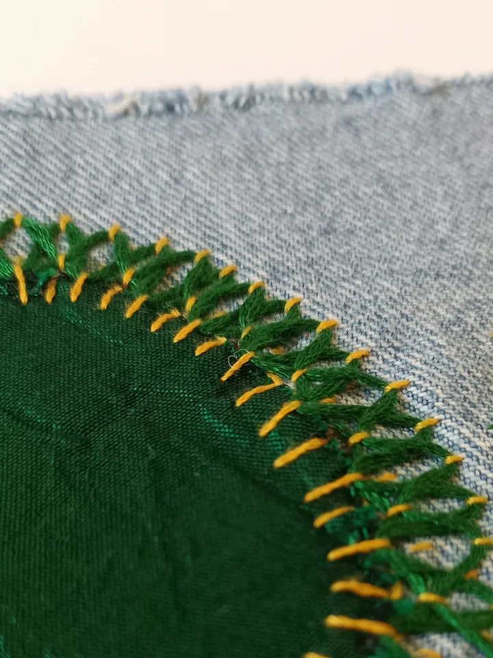 Upcycled denim boro patch – visible mending.