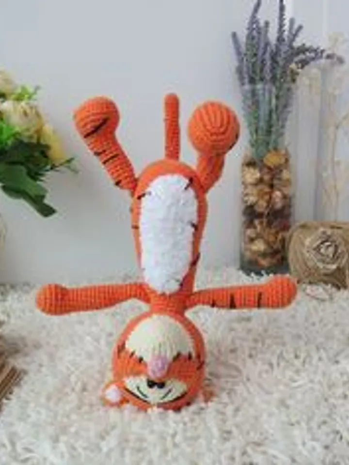 Orange tiger cub Disney cartoon character. Stuffed animal tiger soft toy