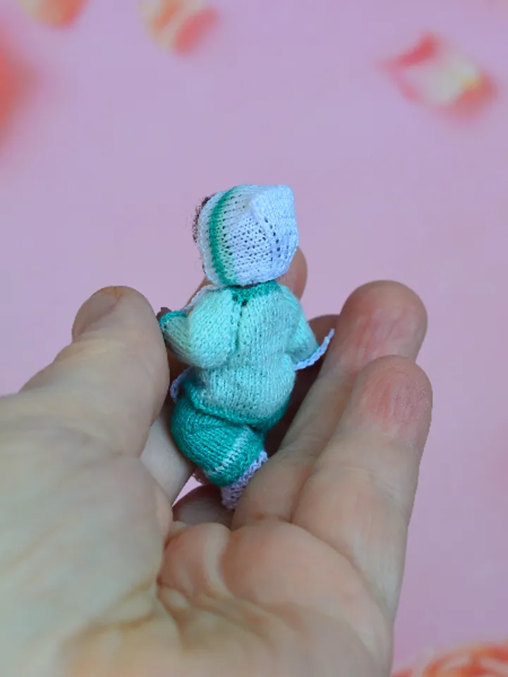 Miniature doll child in 12th scales. A baby for the dollhouse. Baby in a blue suit.