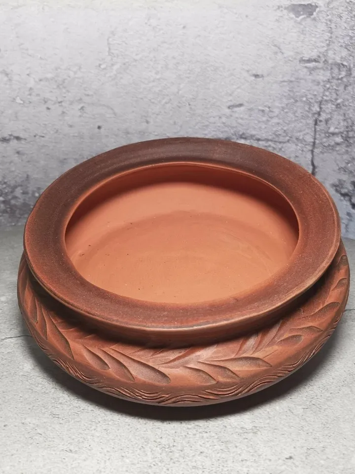 Ceramic casserole with a lid. Handmade from red clay. Carved pattern