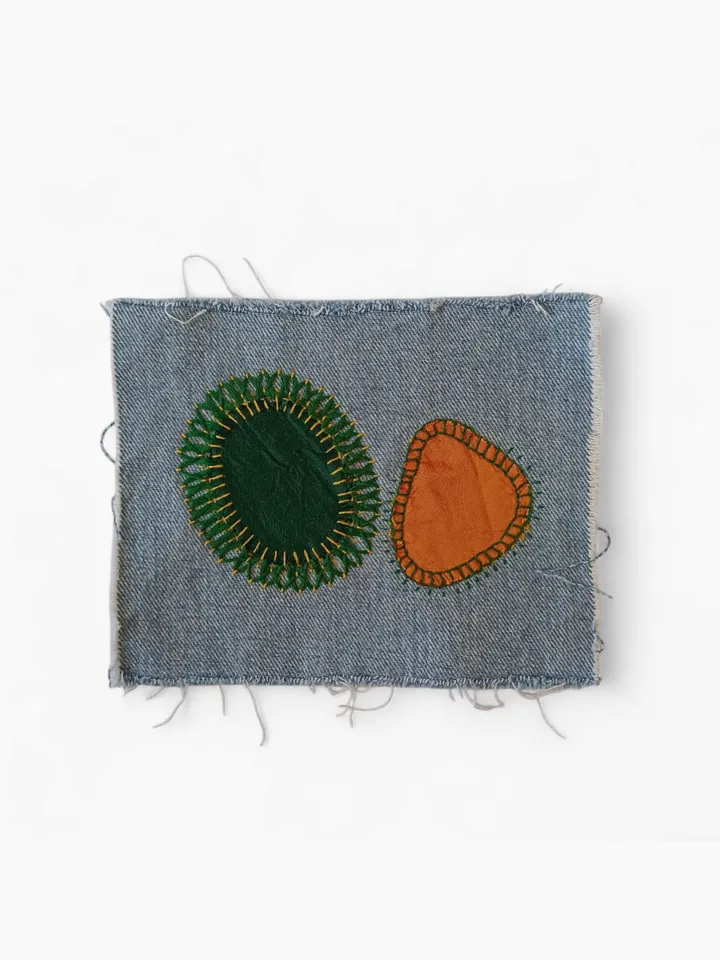 Upcycled denim boro patch – visible mending.