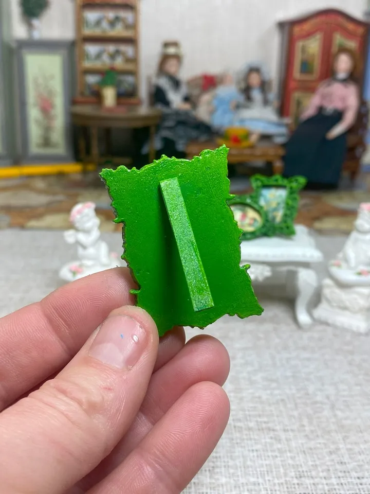 A set of frames with images of flowers. Dollhouse miniature. 1:12.