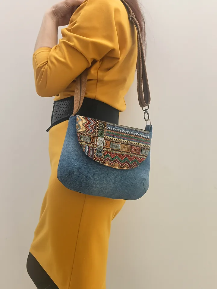 A small crossbody bag, a women's messenger bag with a tapestry flap, a denim shoulder bag with pockets inside and an adjustable strap