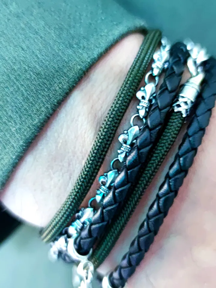 Designer multilayer bracelet with elements of chain, genuine leather and paracord