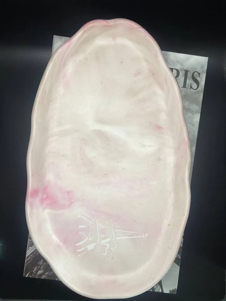 Handmade oval decorative tray made of plaster using marble pouring technique
