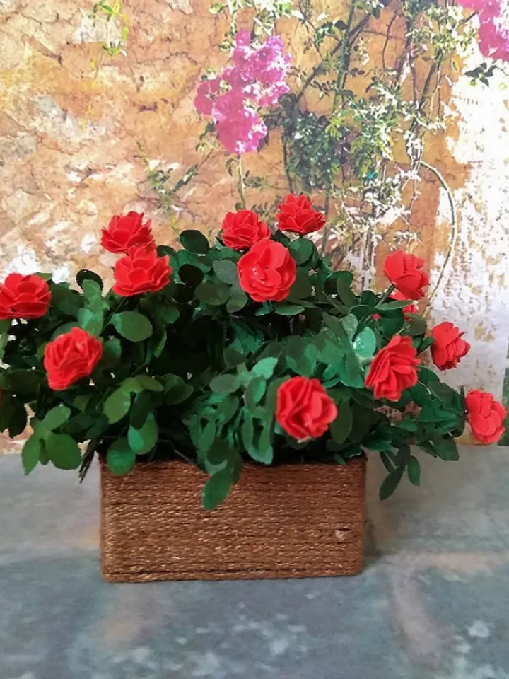Miniature roses in a flowerpot. Dollhouse miniature.