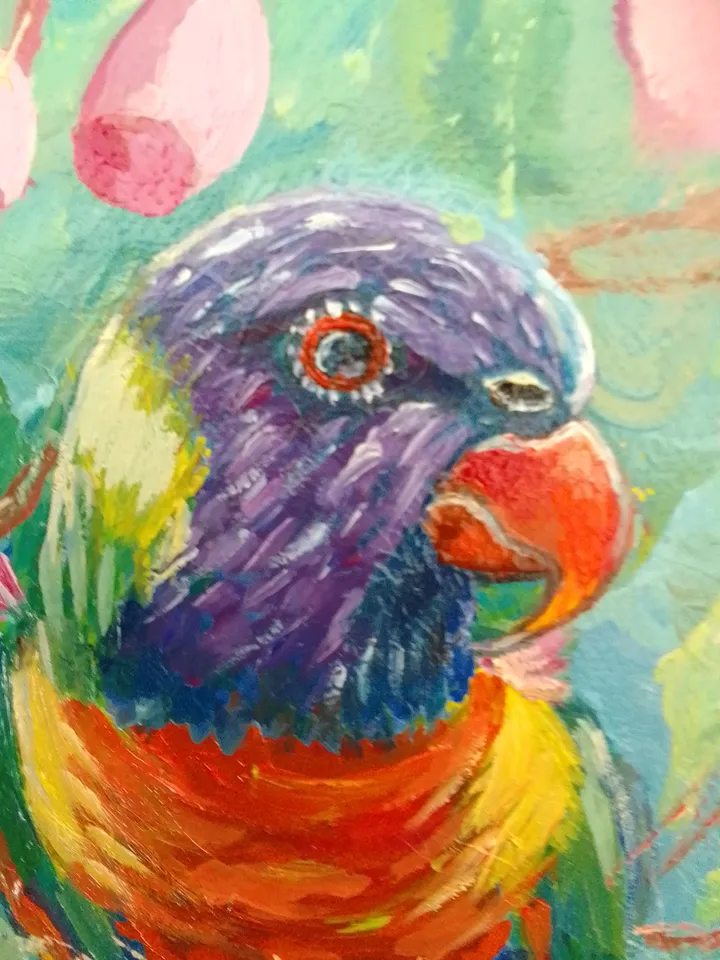 Parrot sits on a branch of a flowering tree