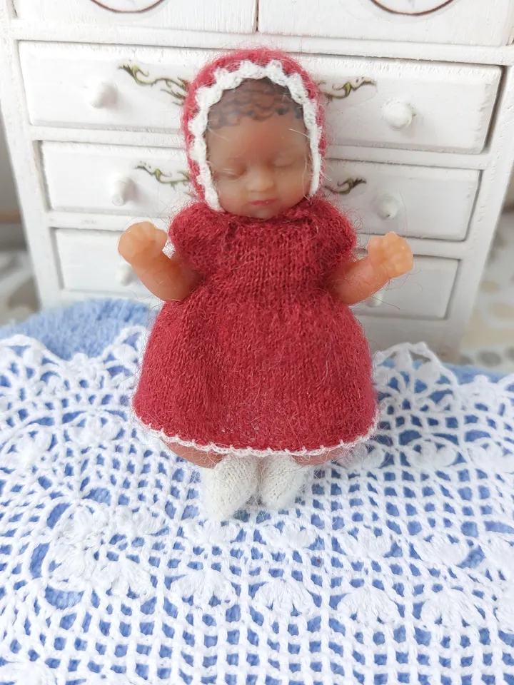 Miniature knitted red dress with white pants, socks and a hat for the silicone doll "My Mini Baby" by ZURU