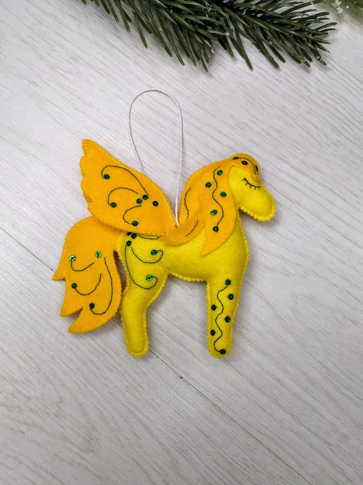 Pegasus in ancient Greek mythology is a winged horse, a favorite of the muses. Yellow felt toy Pegasus